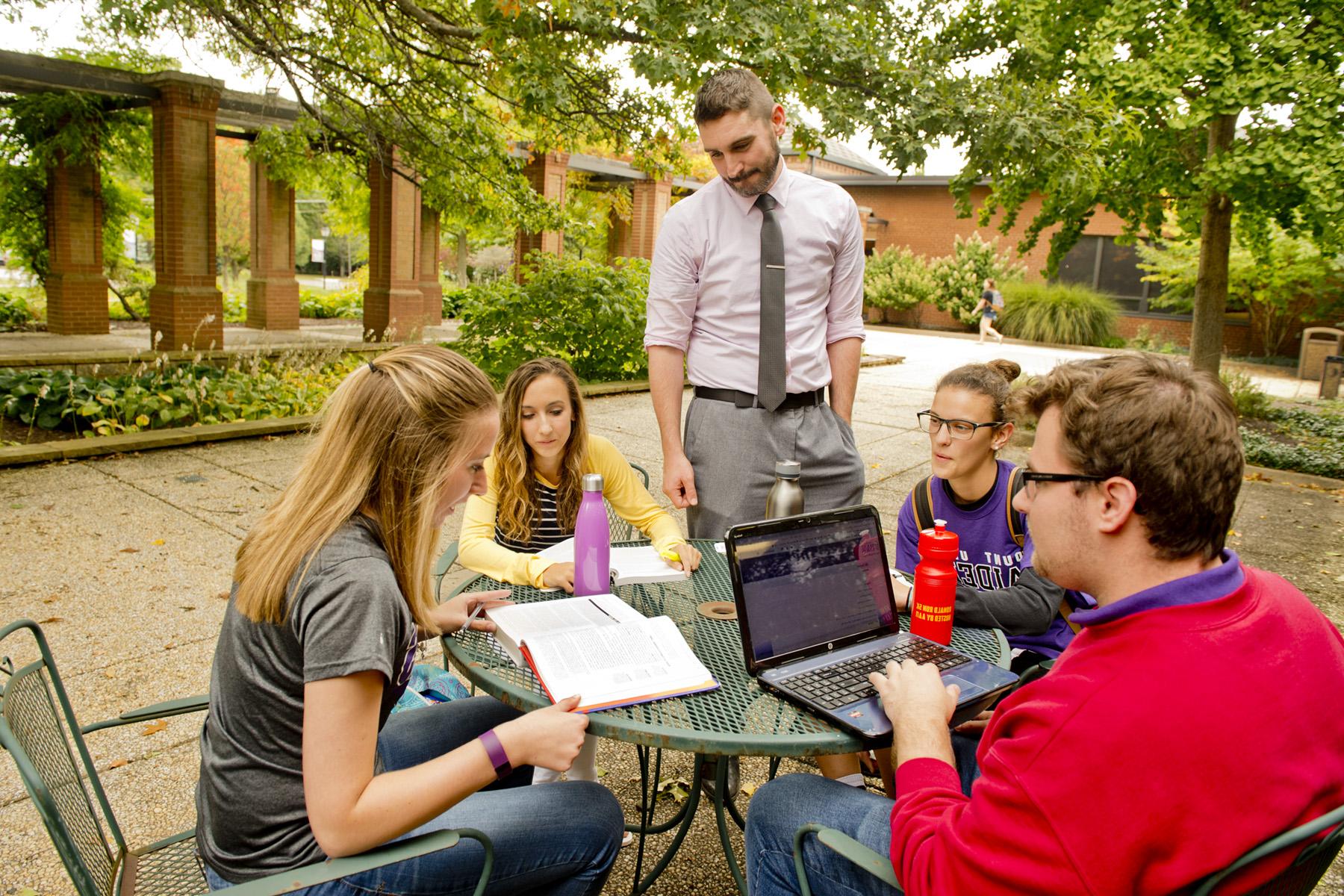 University of Mount Union students working with professor outdoors.